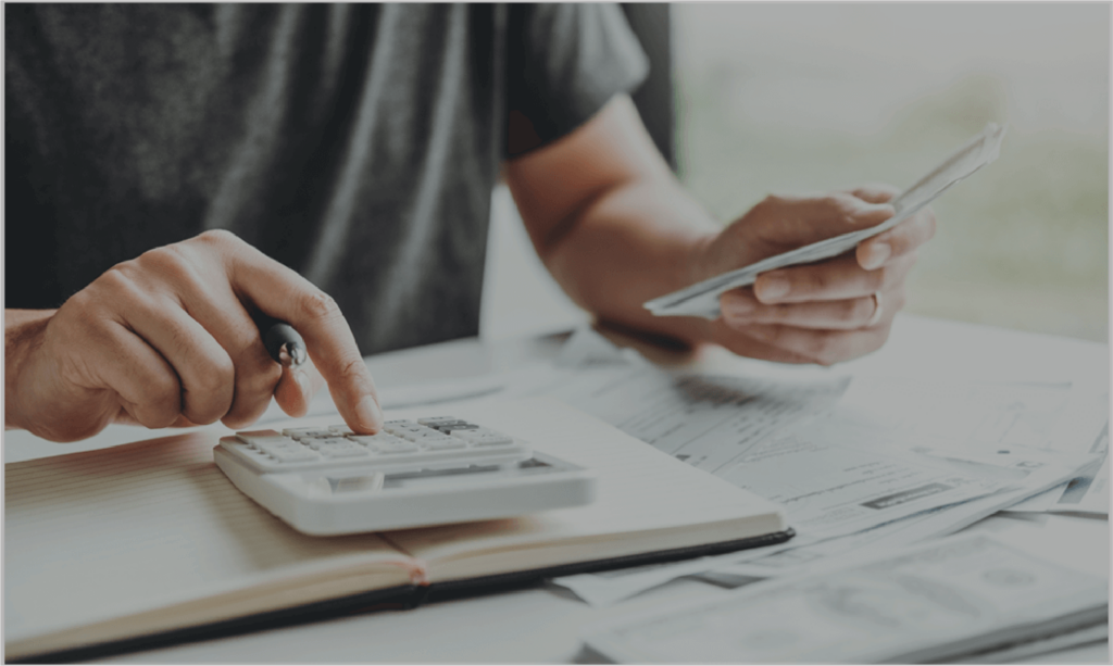 Person using calculator to add up financials