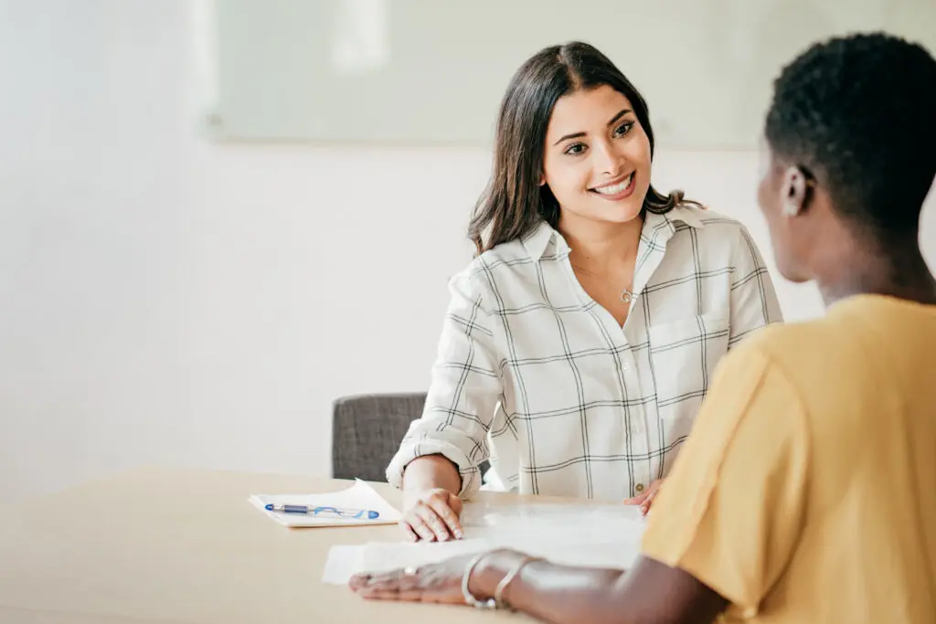 Lady smiling at a person across the table from her