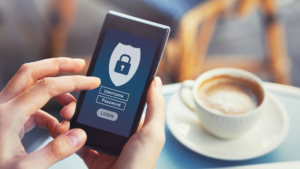 Phone with a security login screen with a blurred out latte in the background