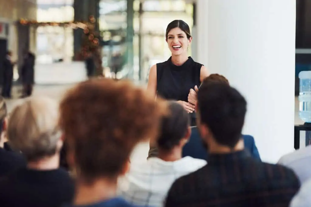 Shot of a young businesswoman delivering a speech during a conference