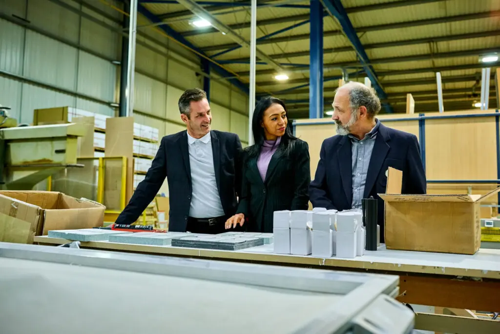 Team of business people checking goods in distribution warehouse