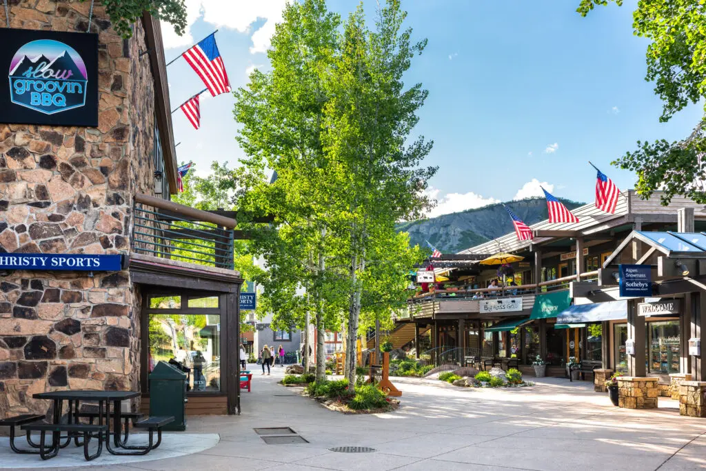 Snowmass village, Aspen with shopping mall in Colorado downtown with sports store and Sotheby's real estate