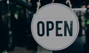Open sign hanging in business window