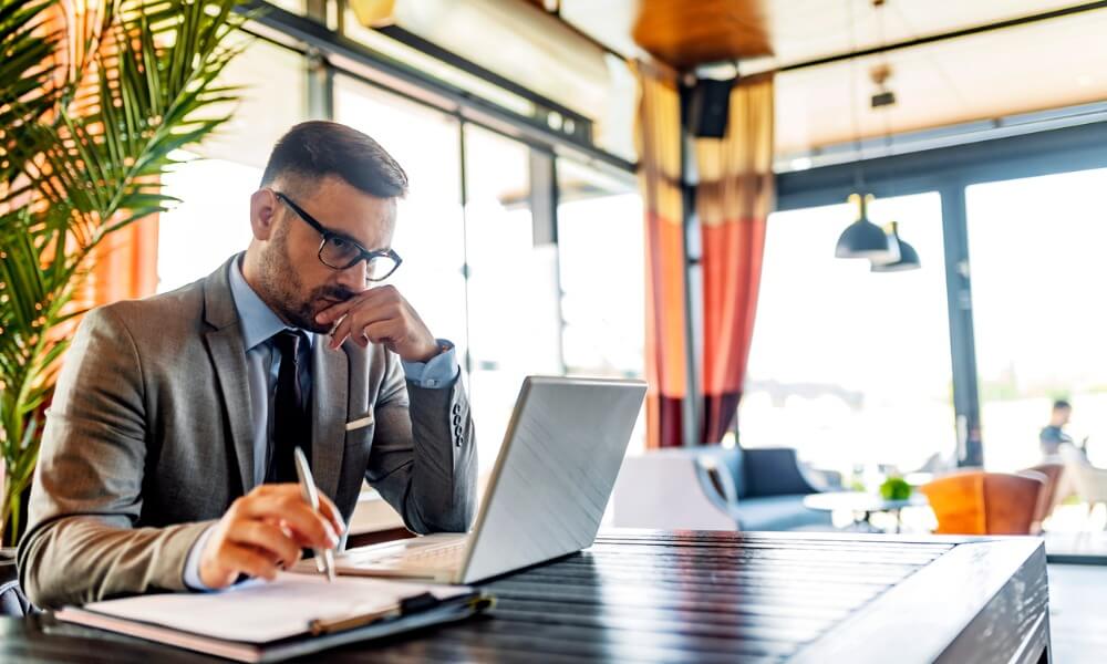 Business man in suit focusing on computer