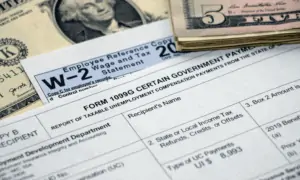 W-2 employee form on table with money around it