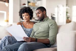 Shot of a young couple going through paperwork at home