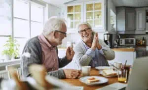 An old couple talking over the breakfast table