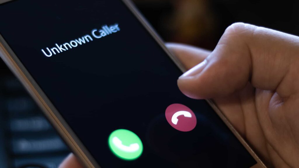 smartphone with call screen on it and "unknown caller" as the caller id. Image for vishing blog
