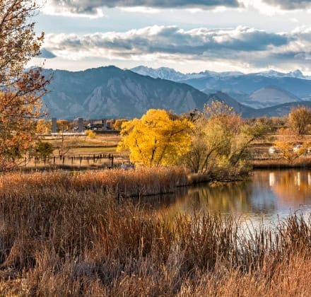 Lake, trees, and mountains in Broomfield Colorado