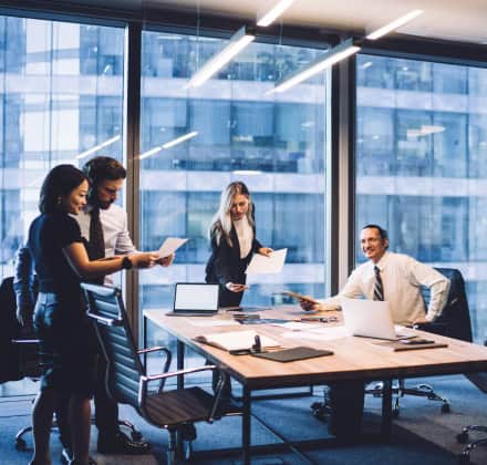 Business team looking at documents in an office