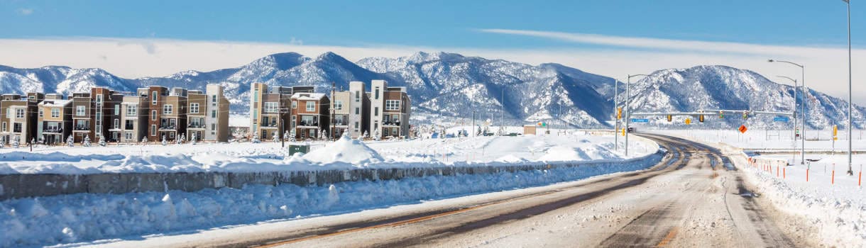 Apartments in Broomfield Colorado with snow-covered mountains in the background