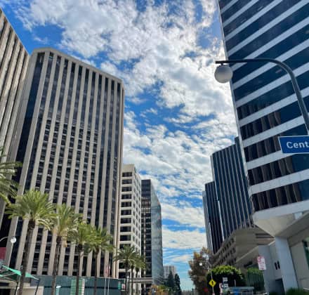 A close up of tall commercial style buildings and blue sky