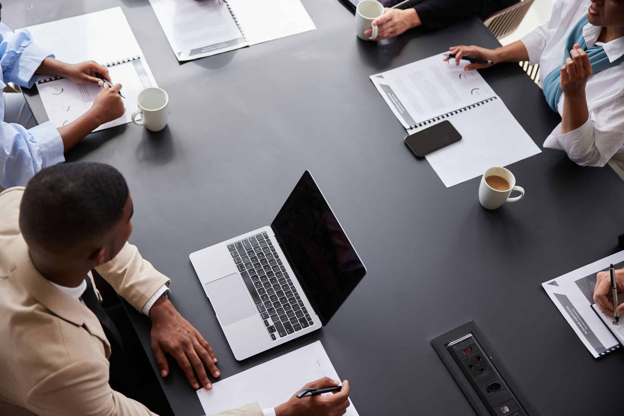 Group of diverse businesspeople meeting around a boardroom table